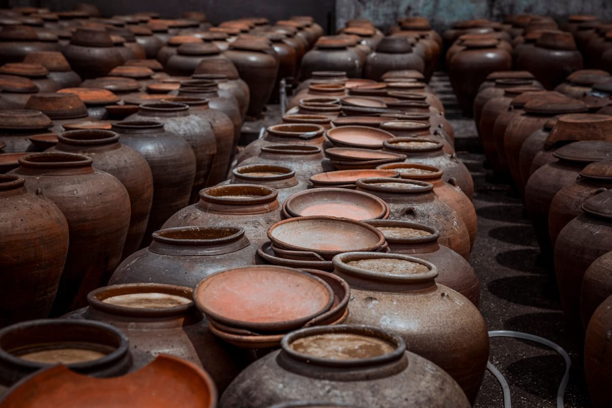 Rows of traditional handmade clay pots in a warehouse