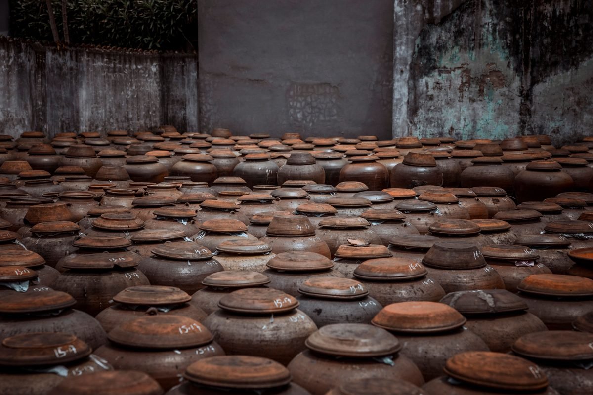 Rustic pottery jars arranged in an indoor storage area