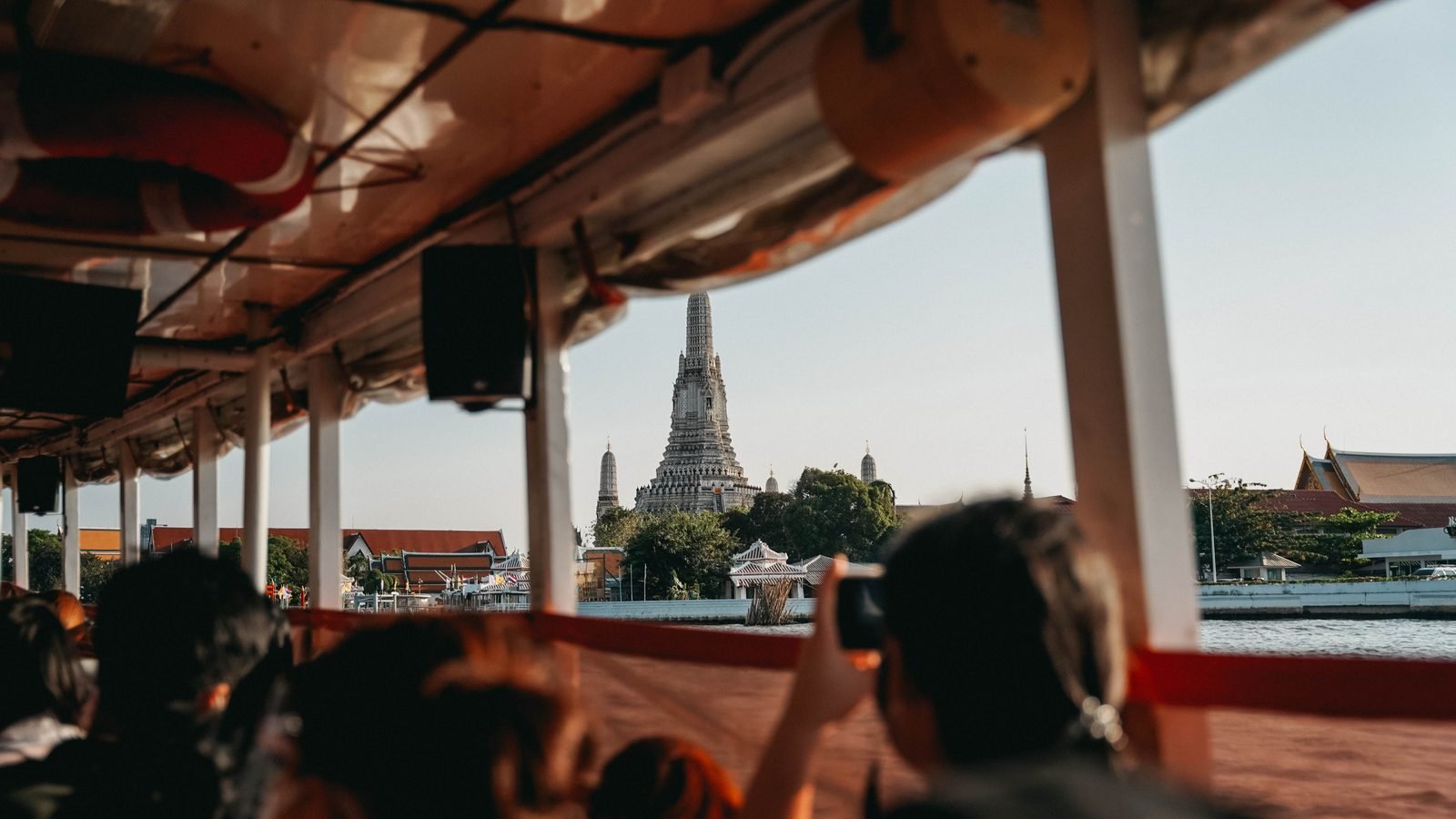 Scenic view of Wat Arun temple from a riverboat in Bangkok.