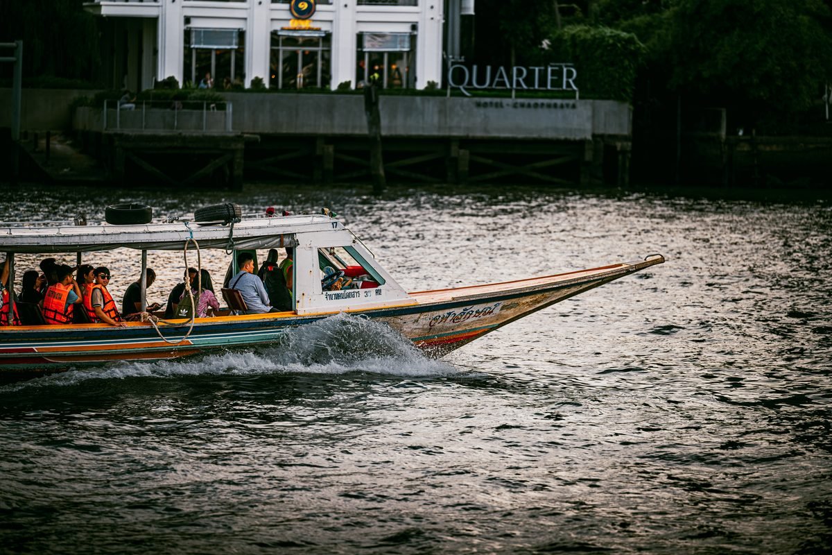 Vibrant longtail boat carrying passengers on the Chao Phraya River.