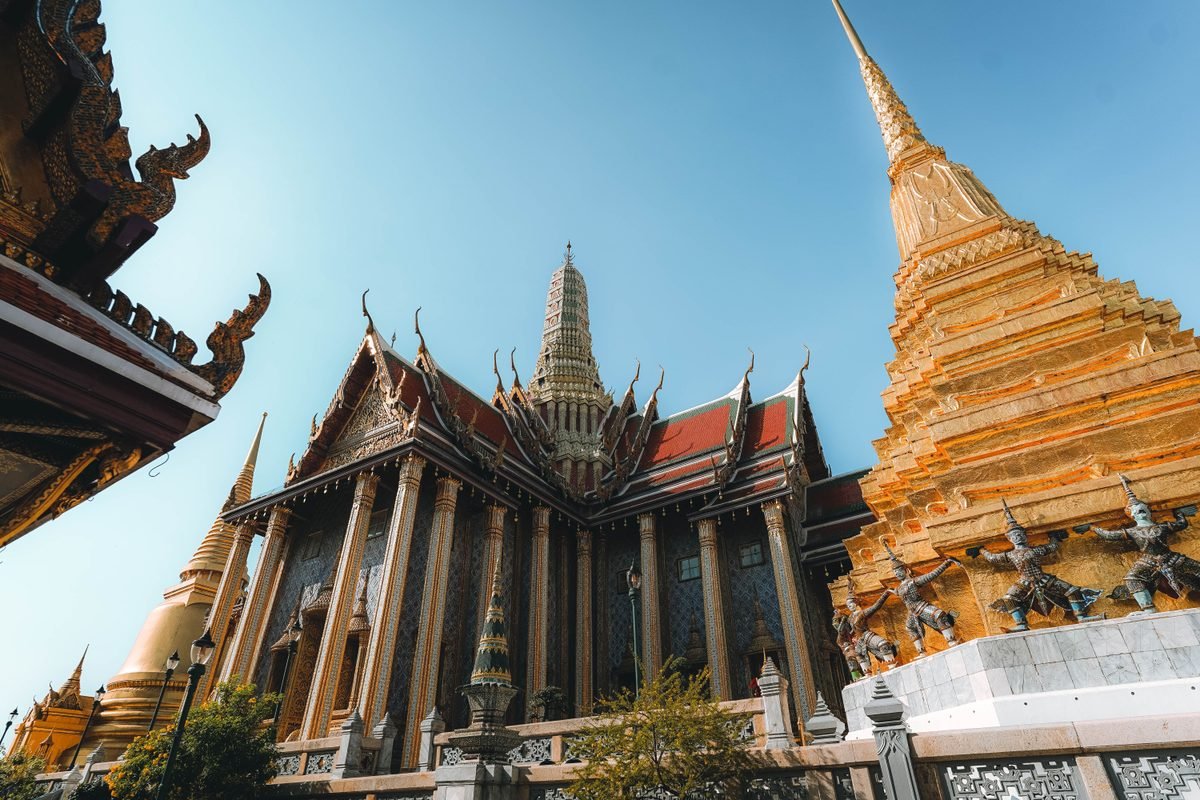 Intricate temple architecture and golden pagoda in Bangkok.
