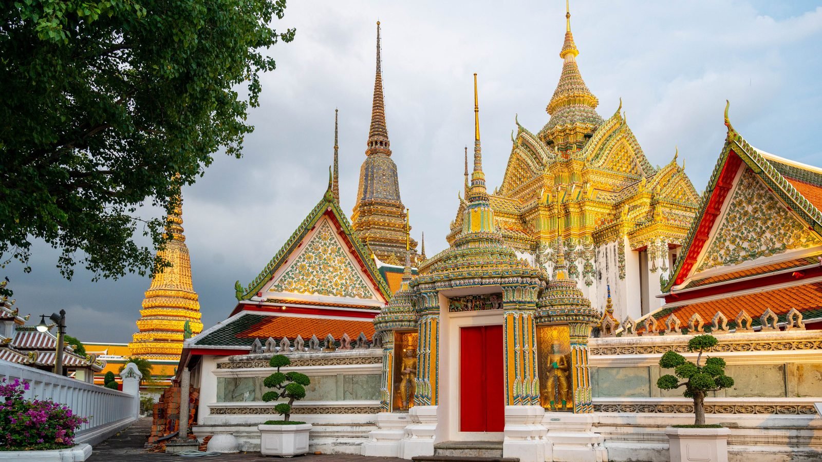 Ornate temple spires and golden stupa in Bangkok.