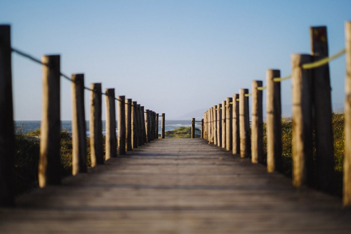Wooden pathway leading towards the sea