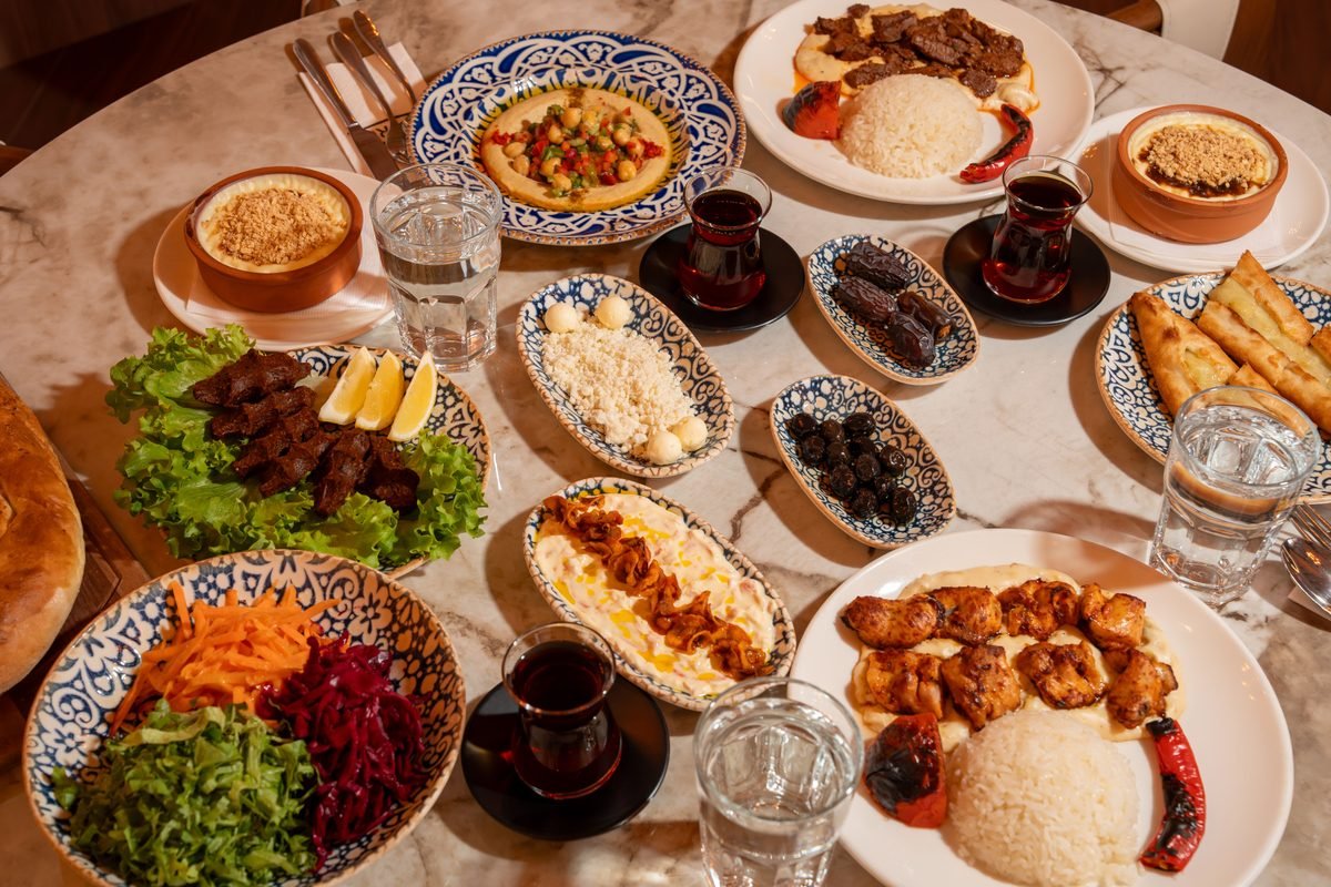 A spread of traditional Turkish dishes including kebabs, mezes, and tea