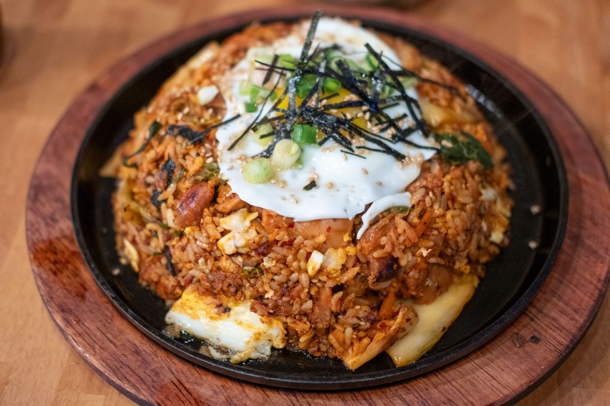 Korean fried rice topped with a fried egg and seaweed flakes