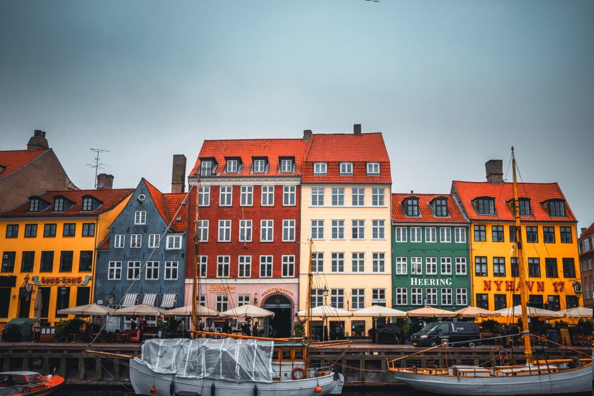 Brightly painted buildings lining the water during daytime in the city center
