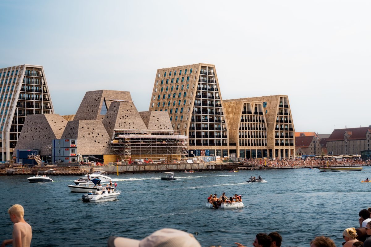 Modern waterfront architecture with people enjoying outdoor leisure by the water