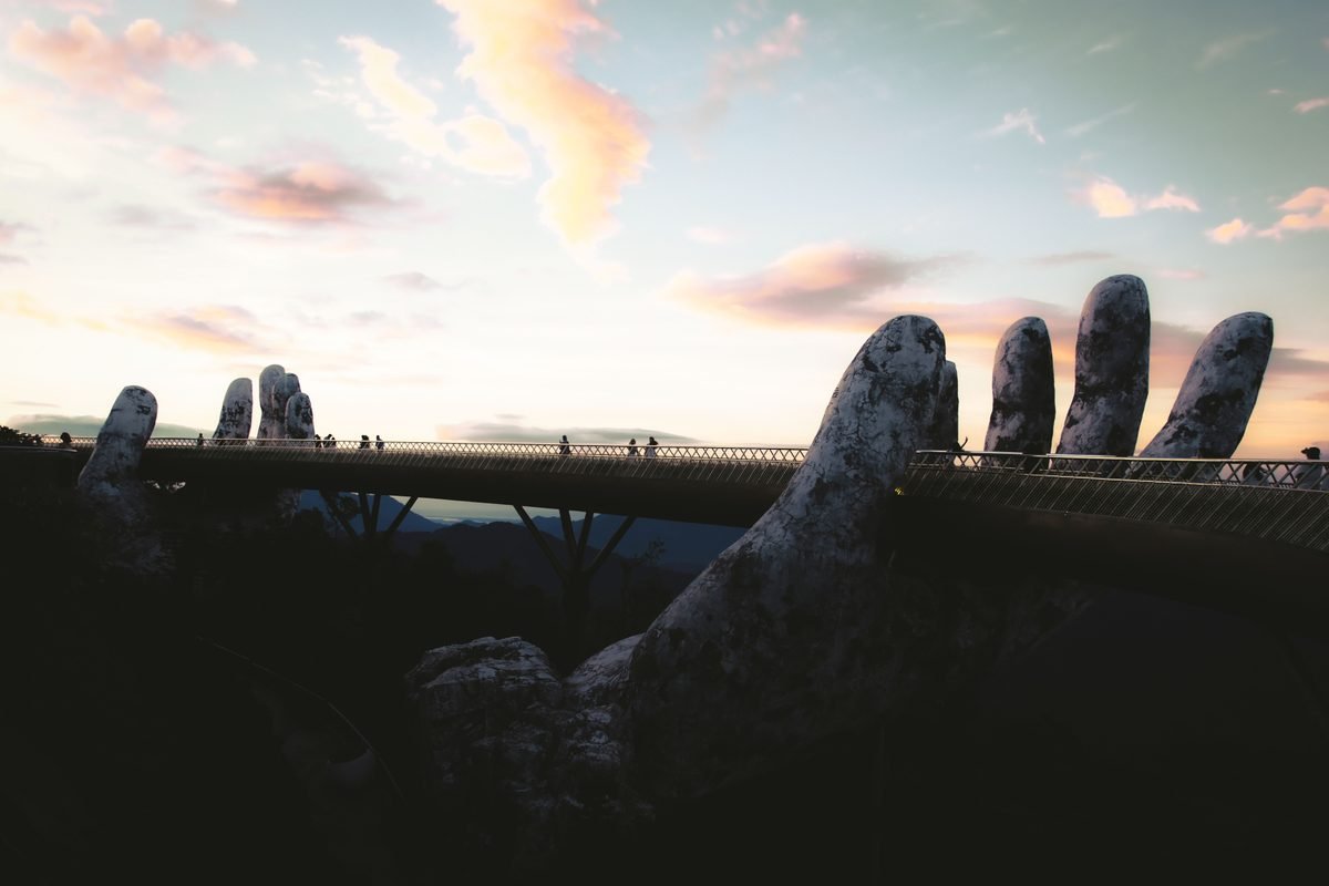 Golden Bridge in Da Nang with giant hands at sunset