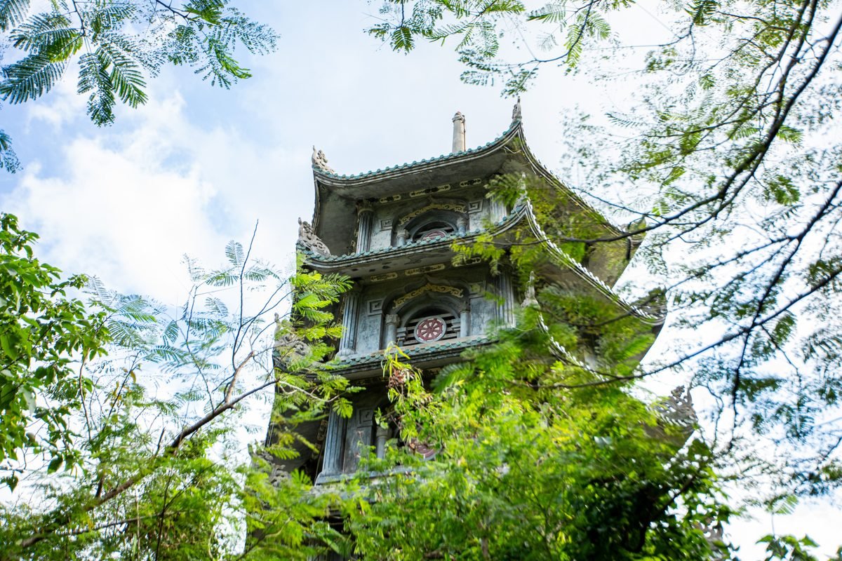 Ancient pagoda surrounded by lush greenery in Marble Mountains