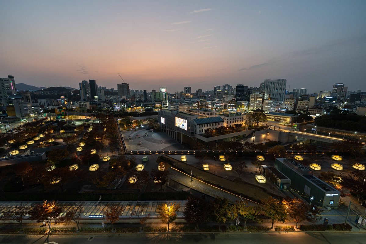 Aerial view of the illuminated Gwangju cityscape during twilight.