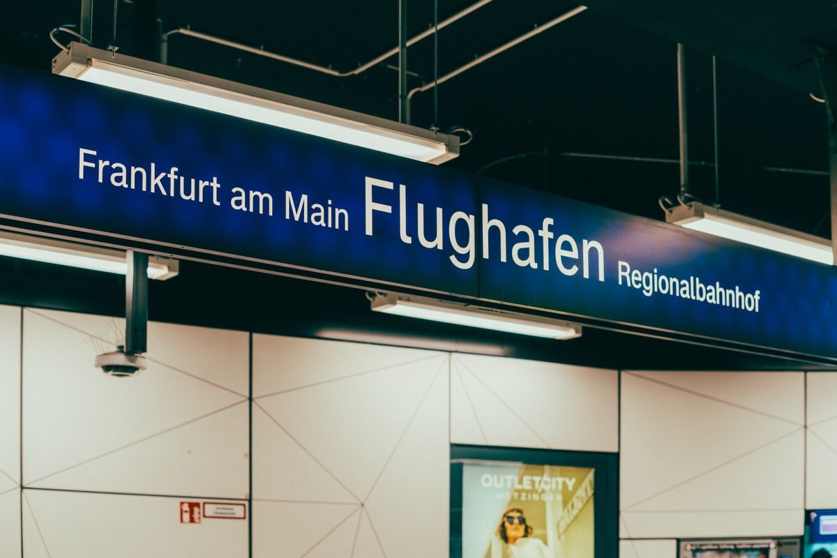 Blue directional signage at airport terminal station