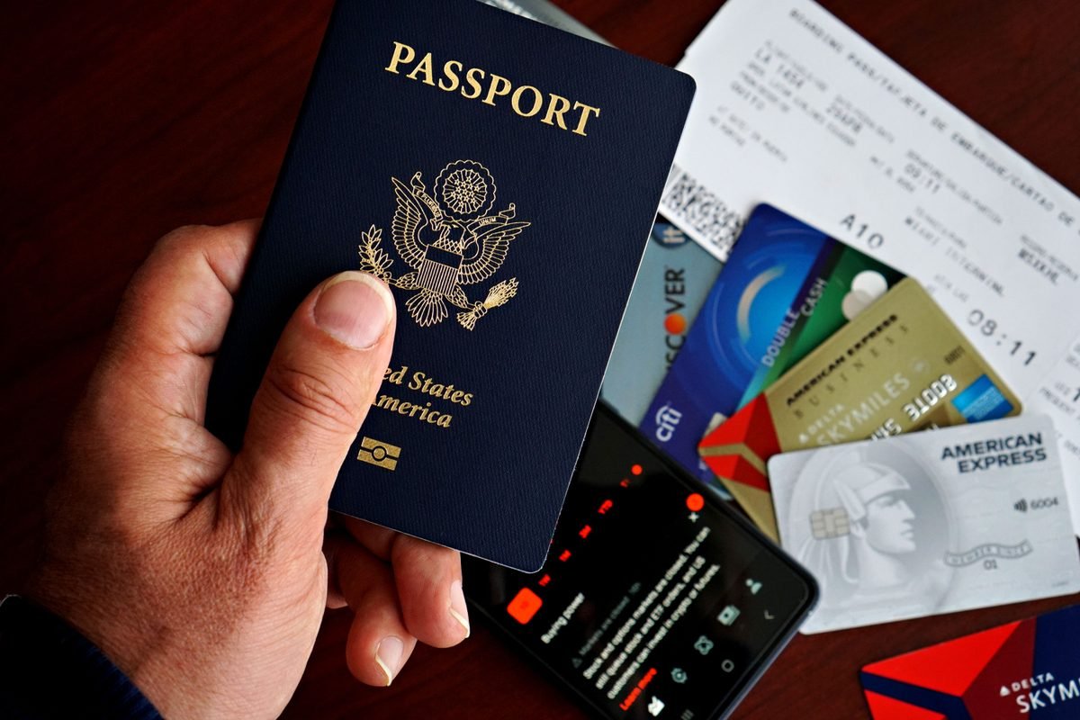 US passport, credit cards, and boarding pass on a desk