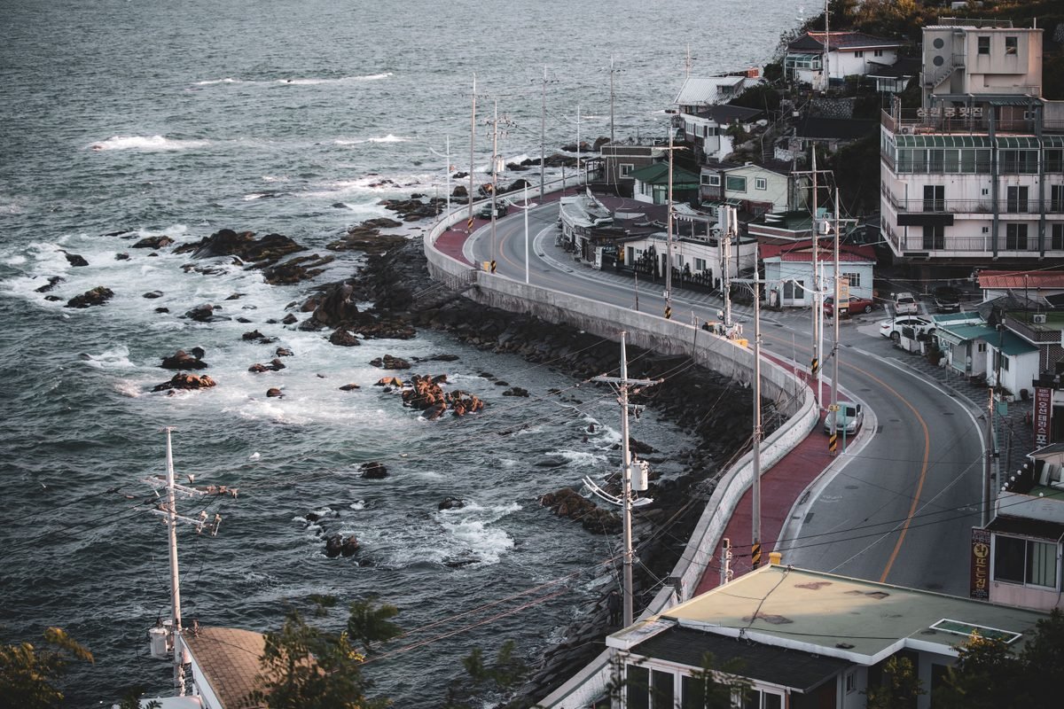 Aerial view of a coastal road and town in Gangneung