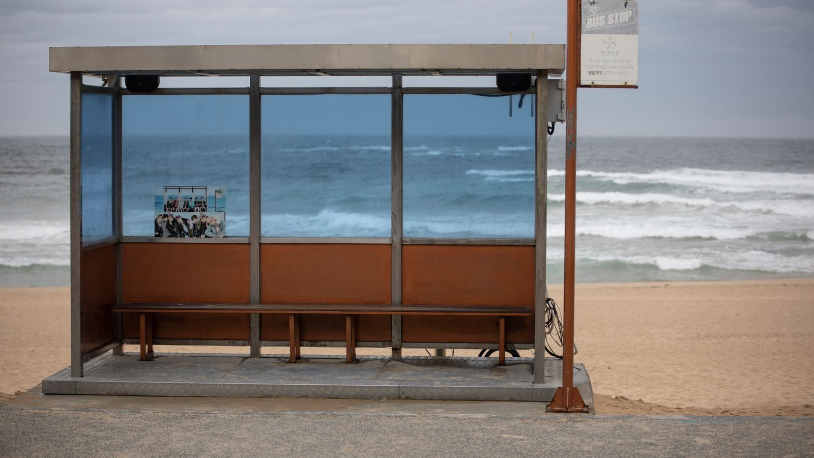 An empty bus stop by a scenic beach in Gangneung