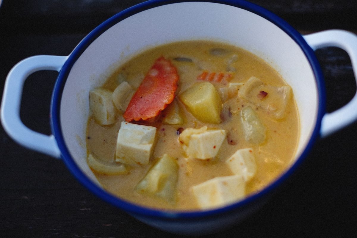 Homemade tofu and vegetable soup served in a rustic pot