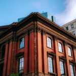 Victorian red brick architectural building facade against a blue sky