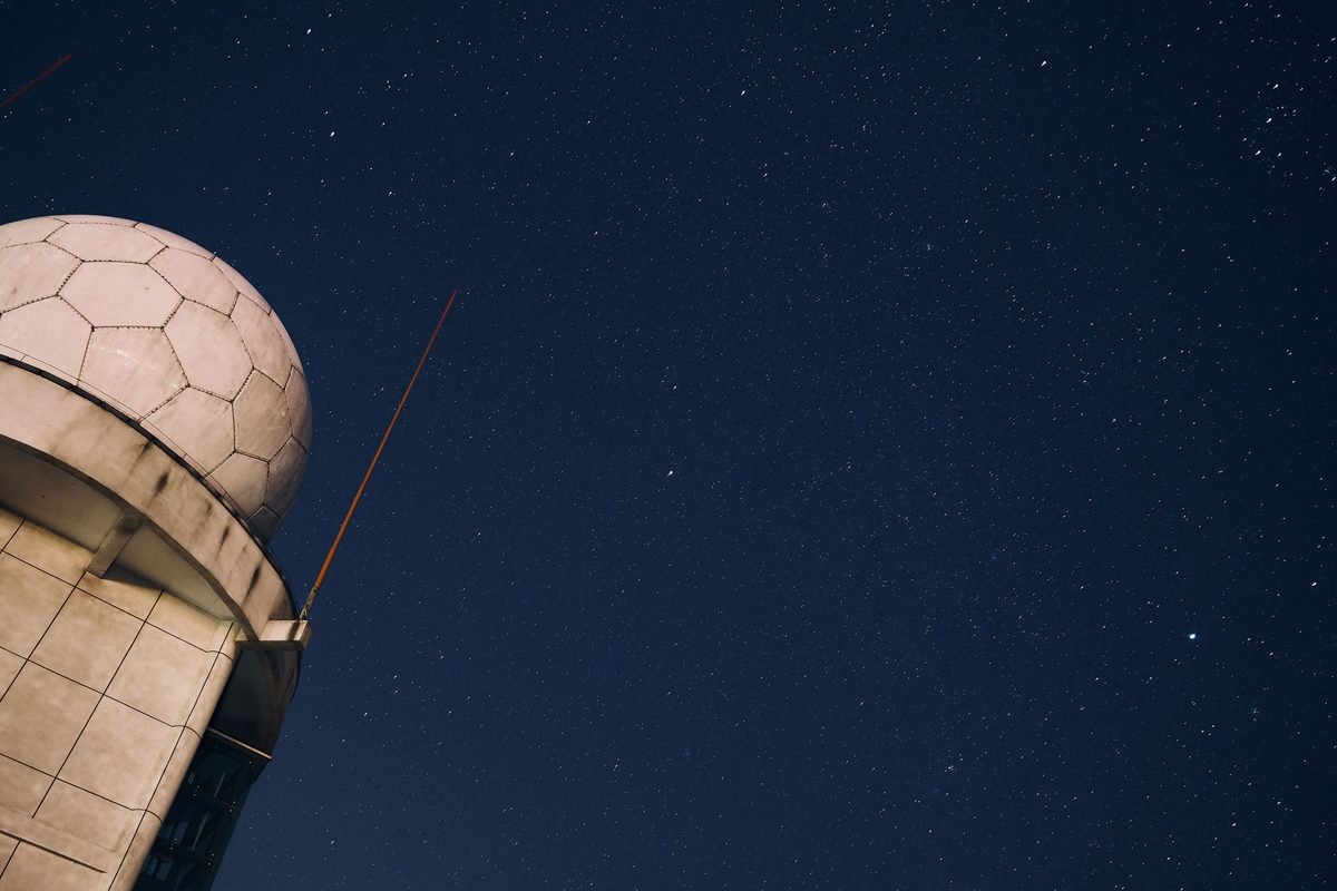 Starry night sky above an observatory dome