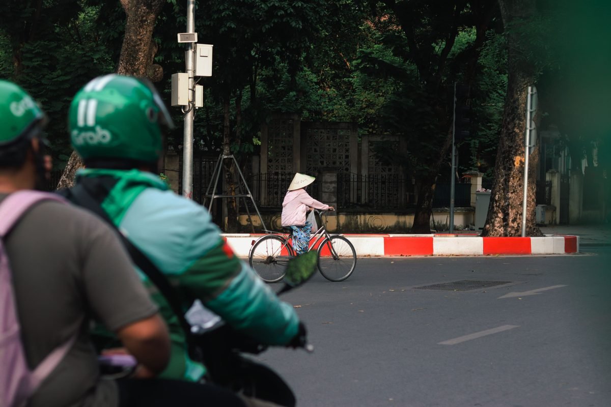 A heavily loaded motorbike navigating a crowded street scene in Vietnam