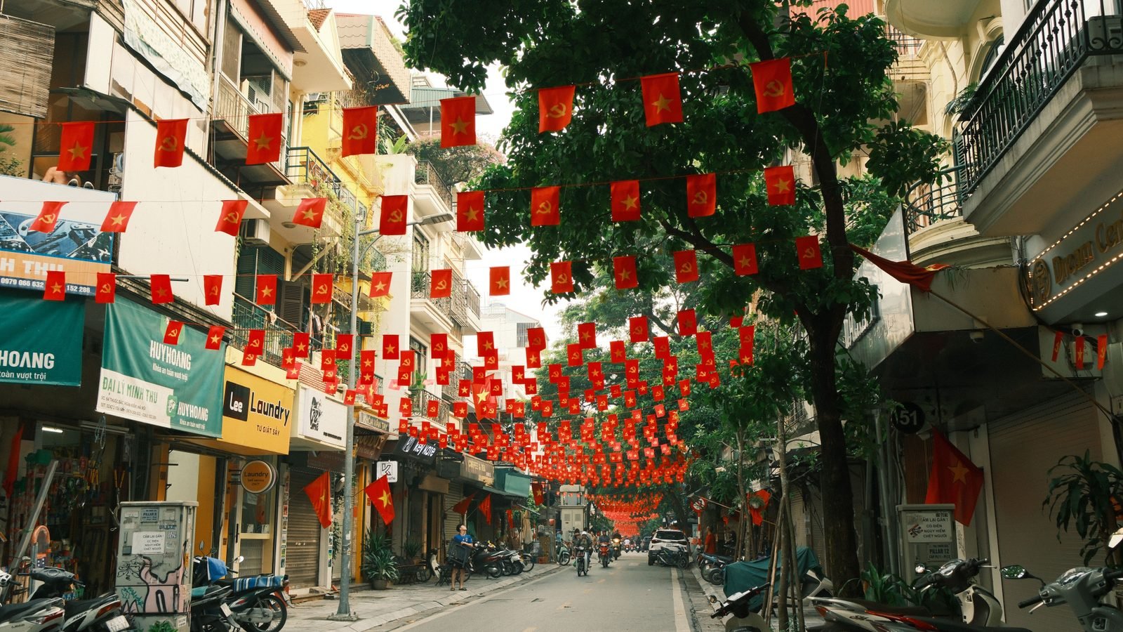 Hanoi street decorated with red Vietnamese flags.