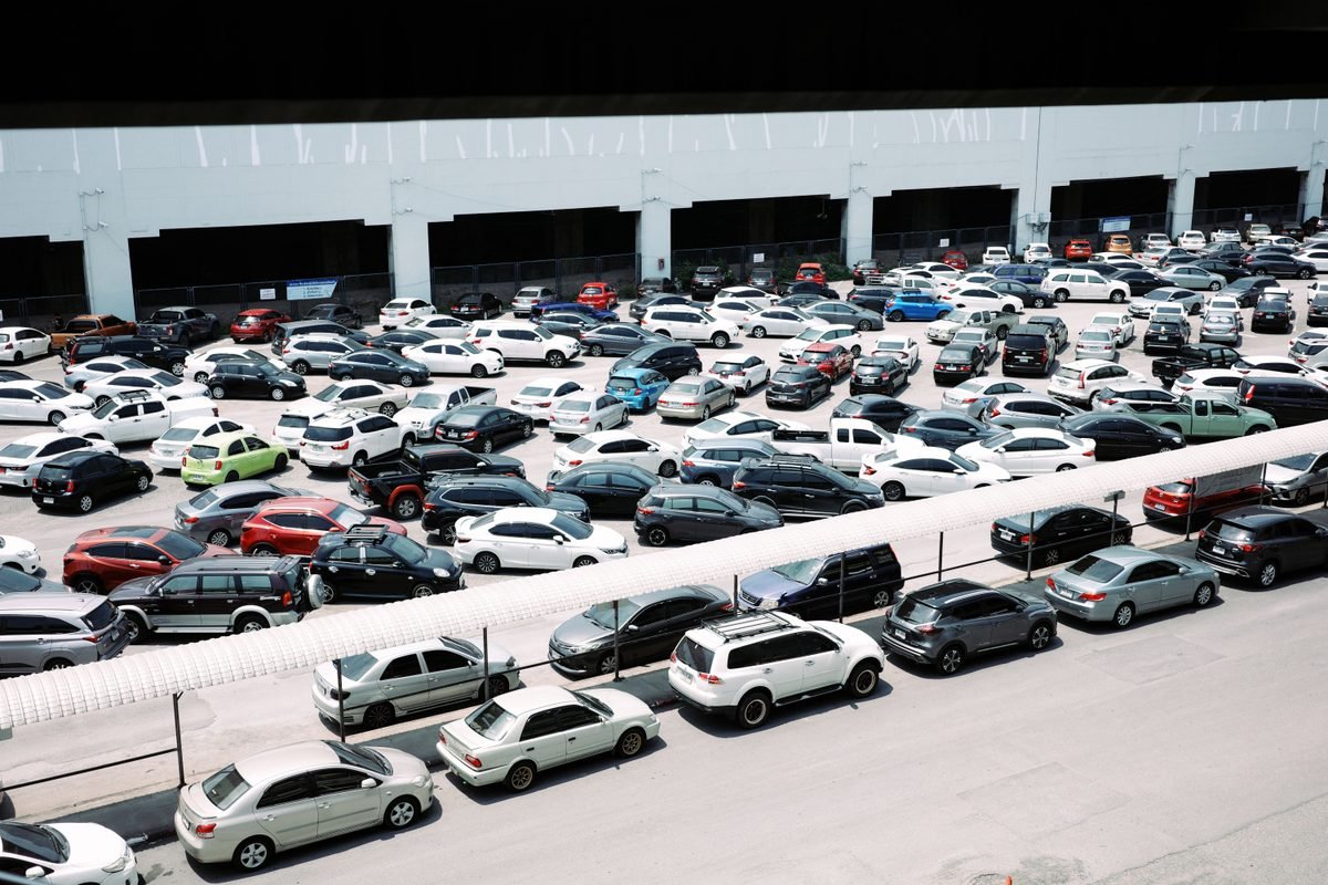 High-angle view of a crowded outdoor parking lot filled with many cars.