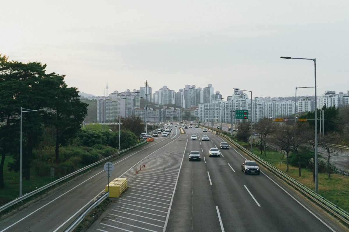 Highway leading into Seoul with high-rise buildings and Namsan Tower.