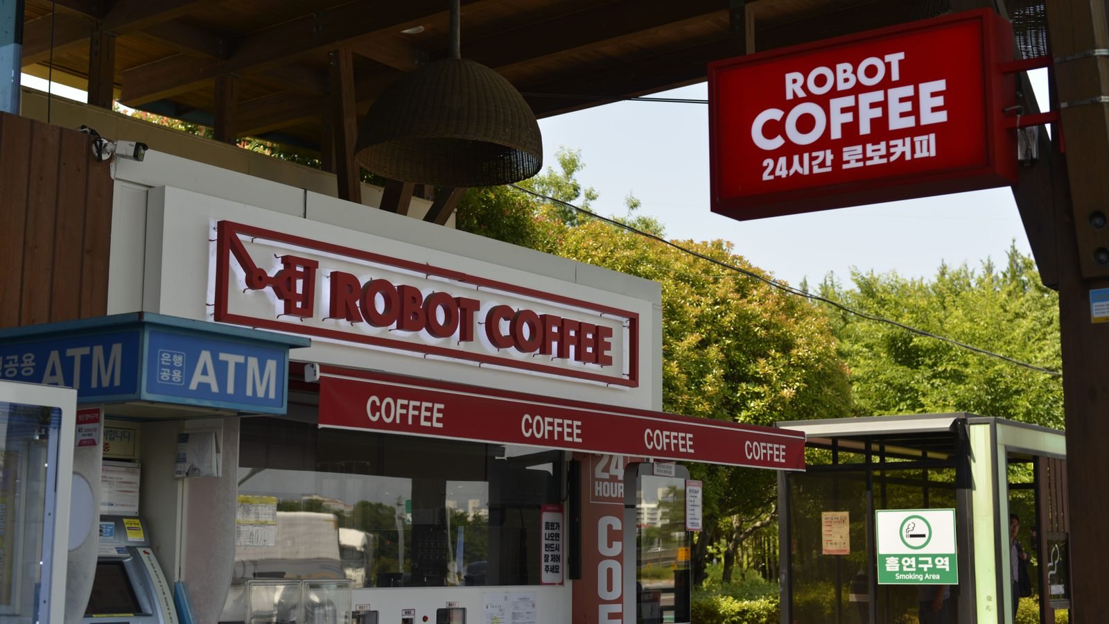 Exterior of a Robot Coffee shop and ATM in Seoul with Korean signage.