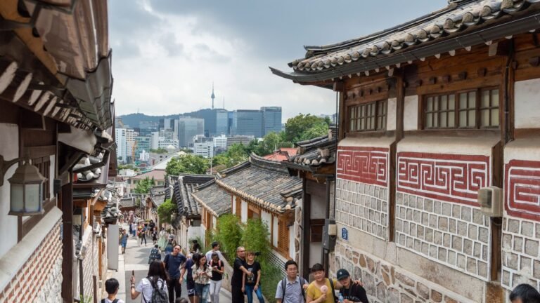 Traditional tiled roofs and narrow alleyway in Bukchon Hanok Village in Seoul.