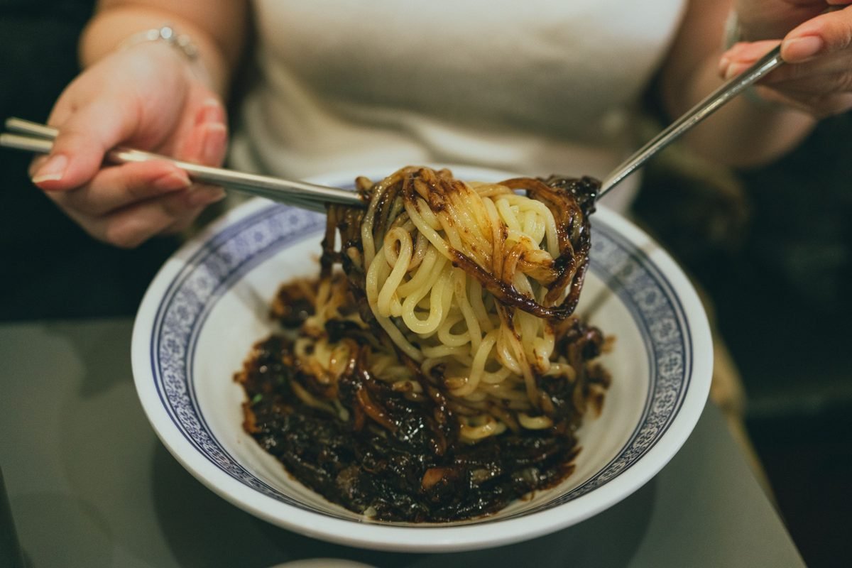Close-up of Korean jjajangmyeon noodles in a traditional bowl