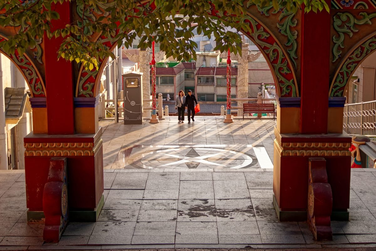 Traditional Korean architectural archway with people in Incheon