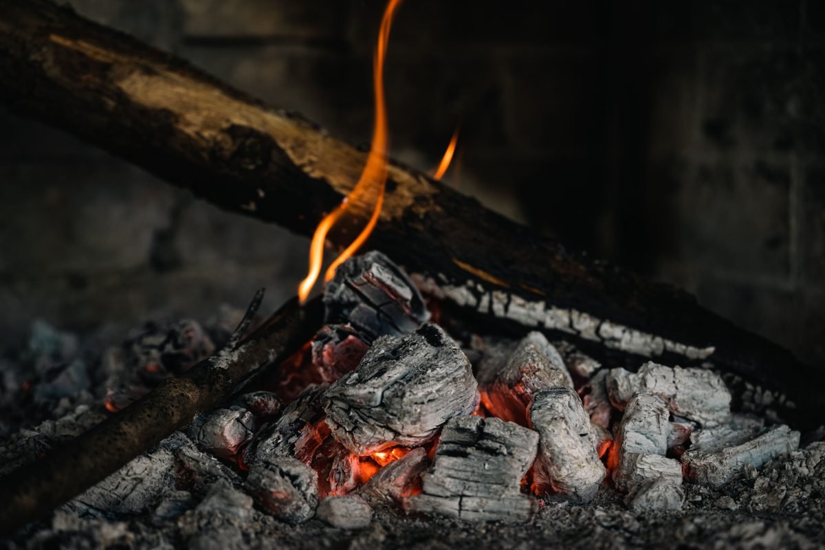 Detailed view of hot embers and burning firewood