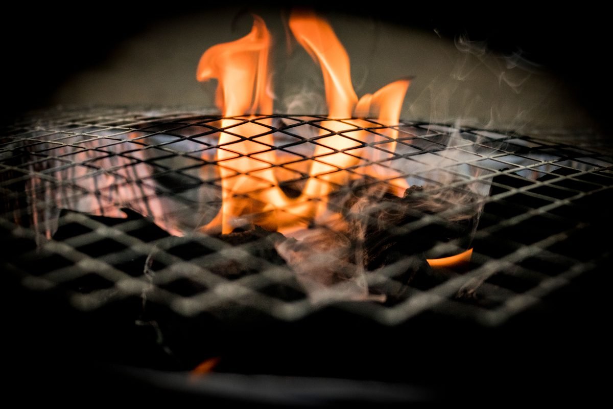 Vivid flames dancing over a grill