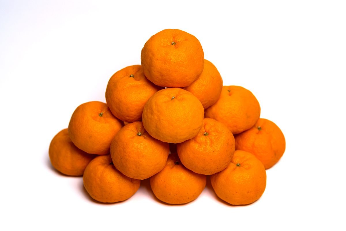 Pyramid of vibrant orange mandarins on a clean white background