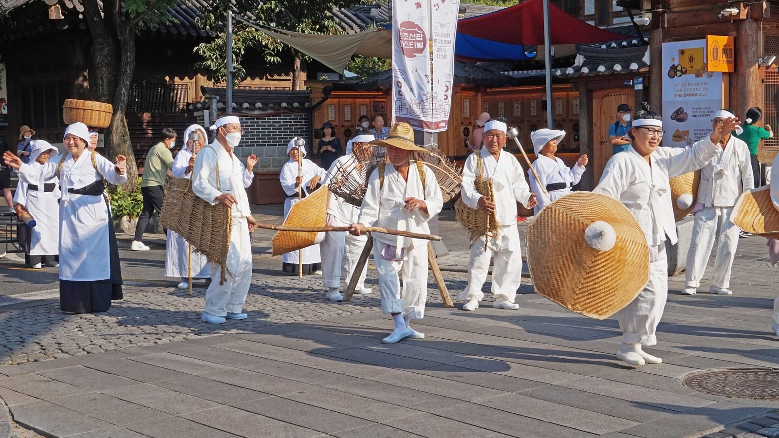 Festival participants in traditional white Korean clothing during a cultural event in Jeonju