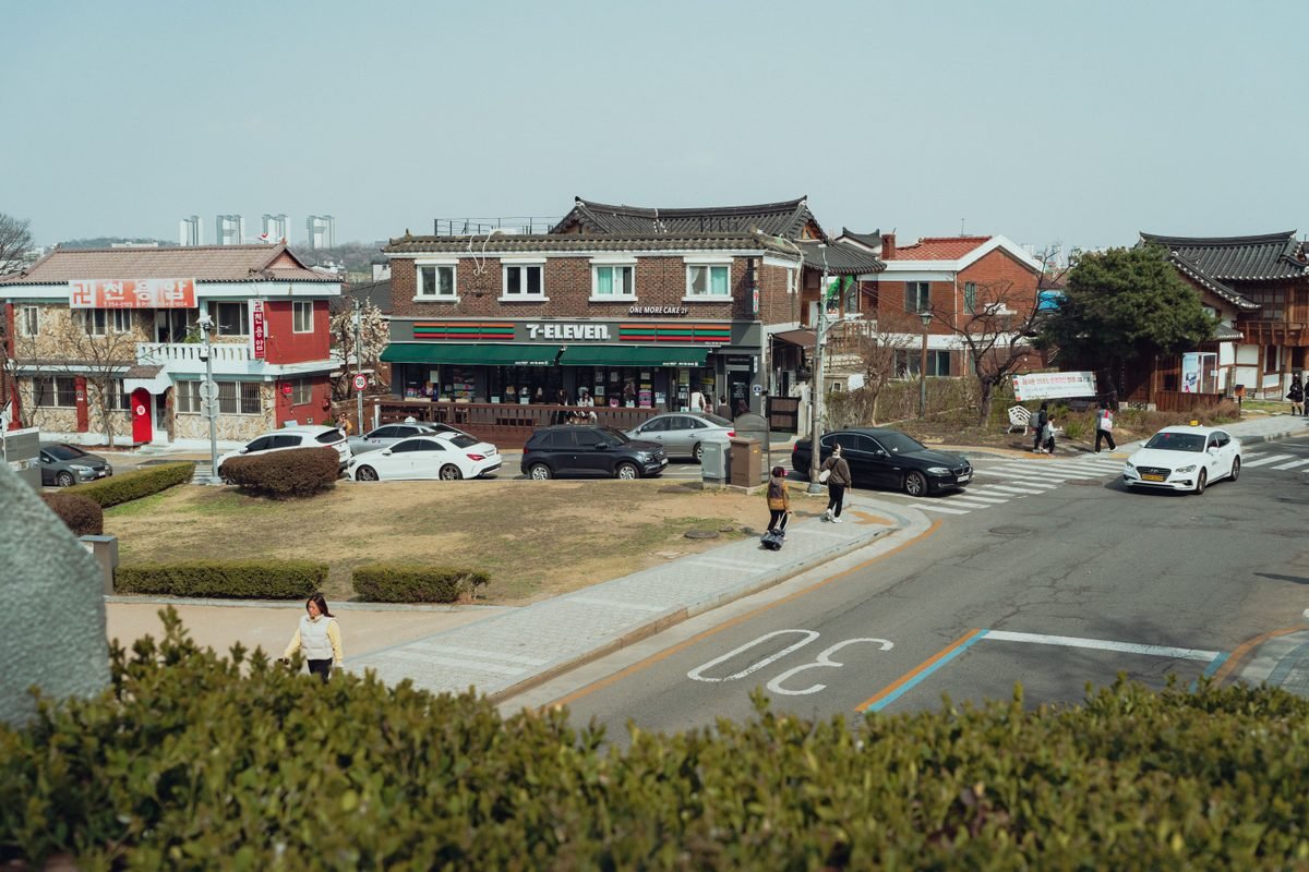 Traditional and modern architecture in a Seoul neighborhood featuring a convenience store