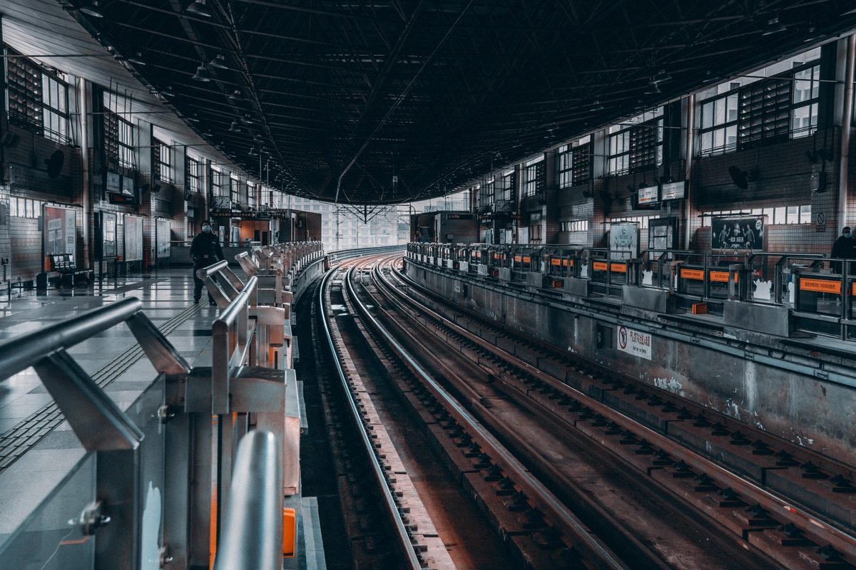 Modern railway station interior showing tracks and platforms