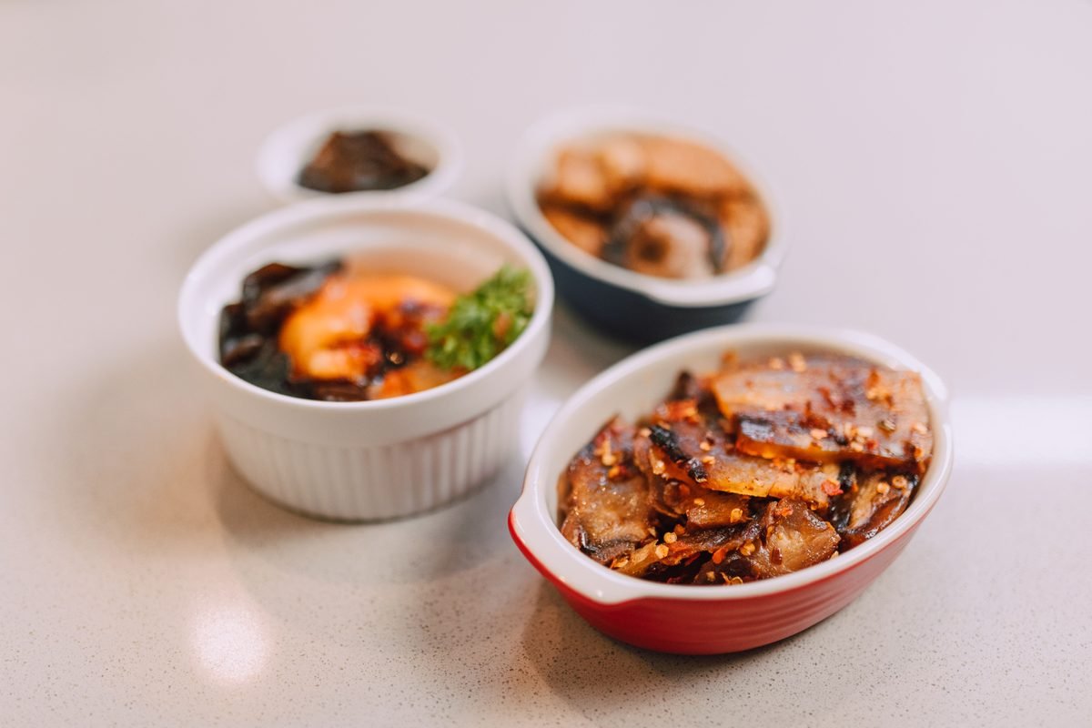 Assorted Korean side dishes in small ceramic bowls.
