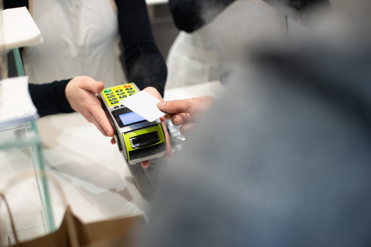 Customer paying with a card at a retail store terminal.