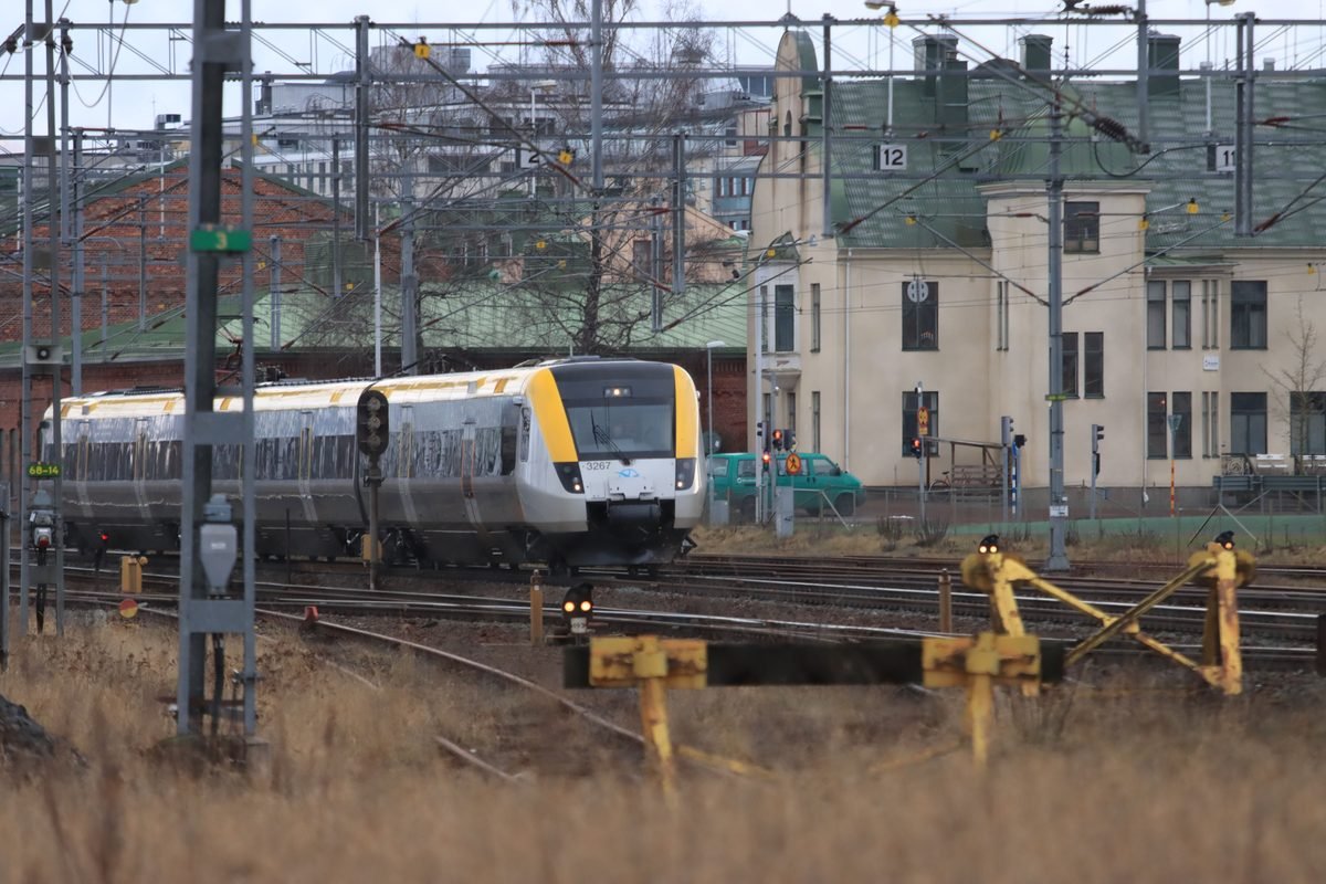 Modern commuter train moving through complex railway tracks