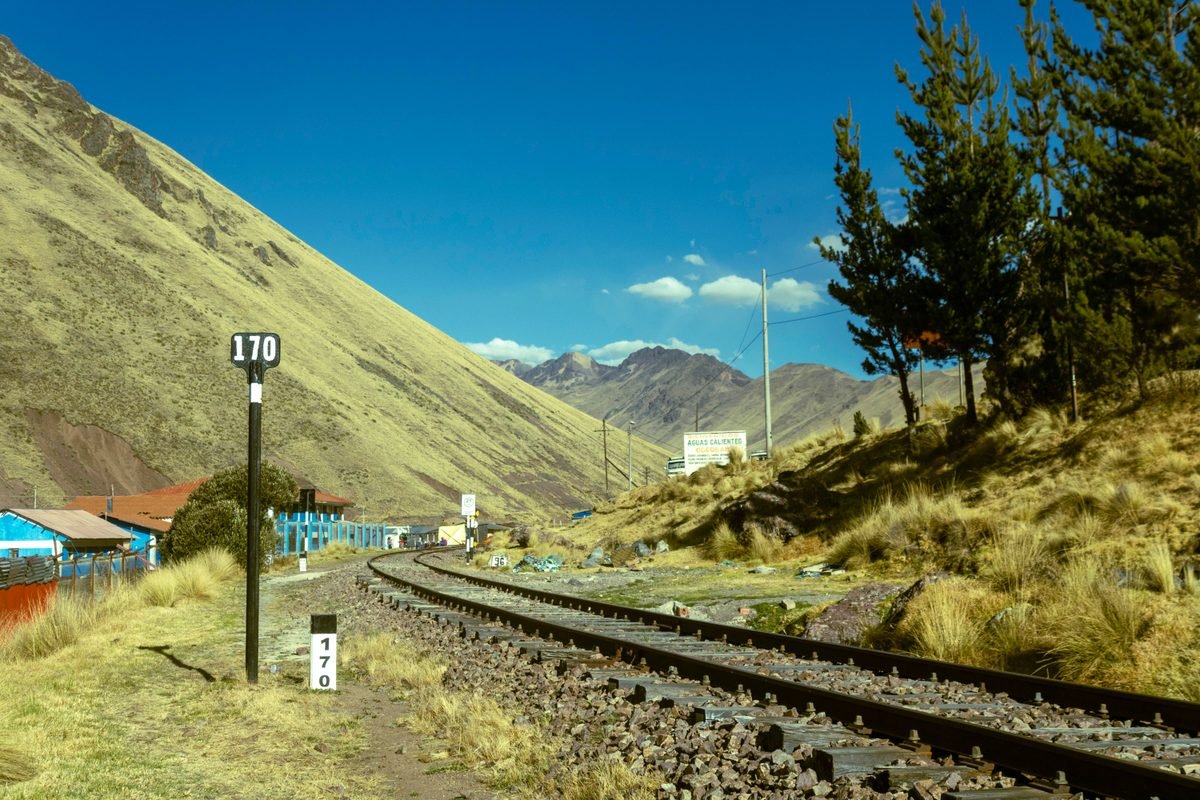 Railway tracks cutting through the mountainous landscape near Cusco