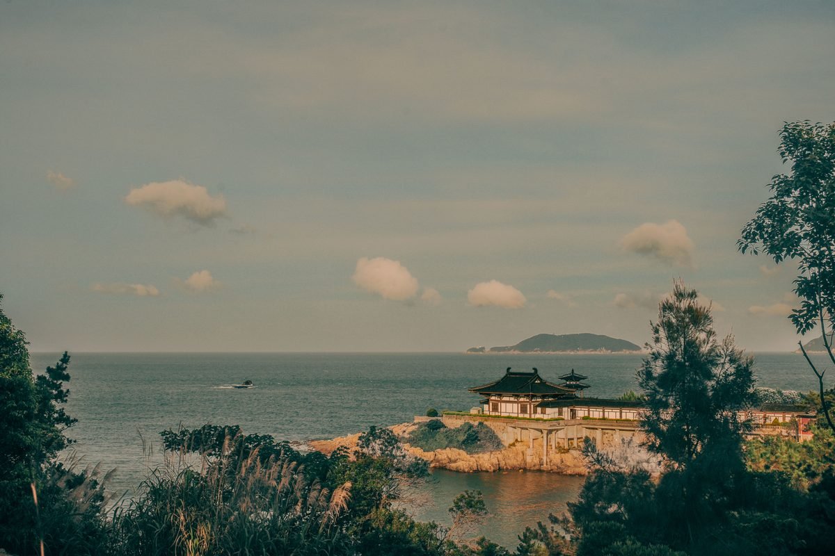 Traditional temple architecture by the calm ocean.