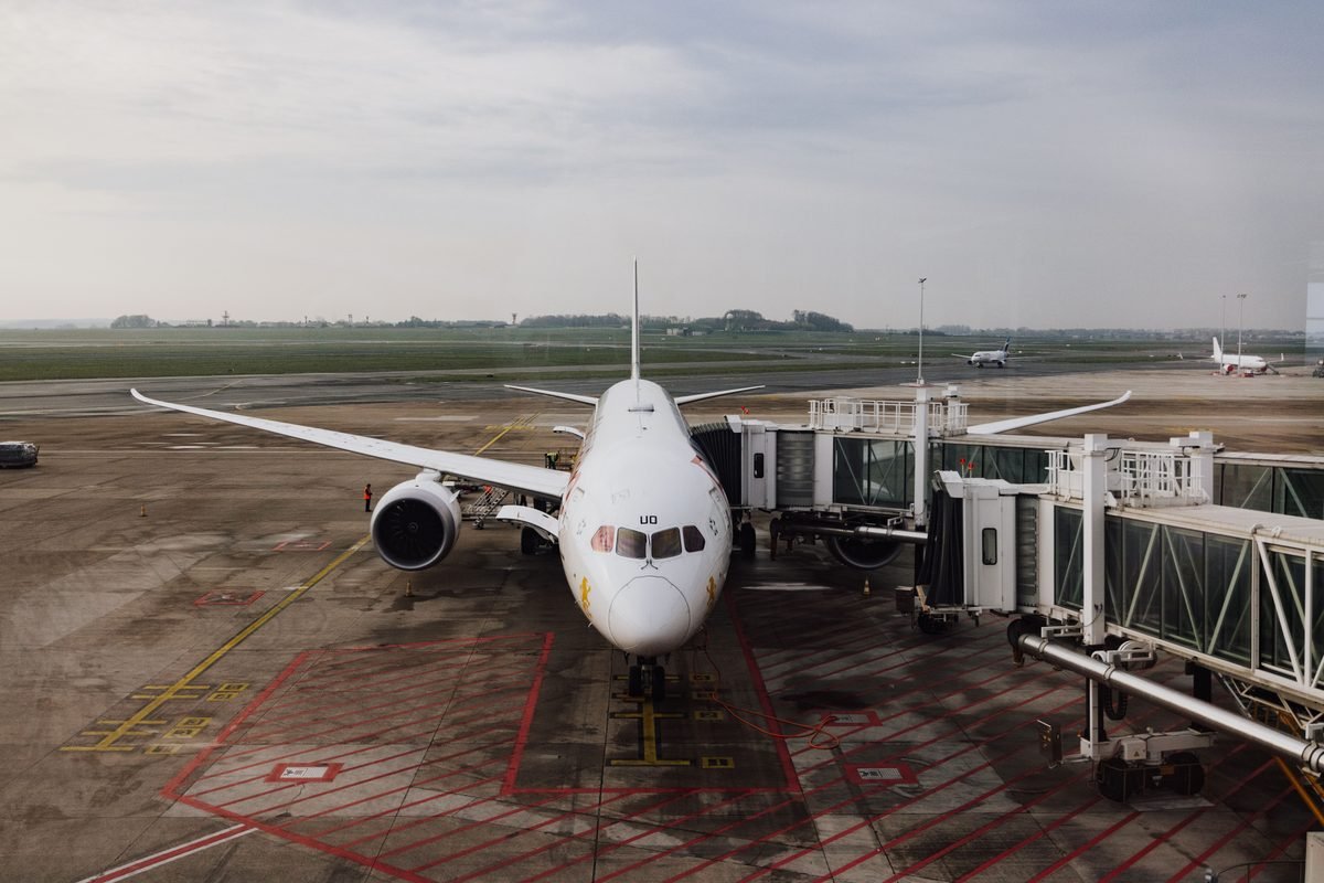 Jet airplane docked at airport terminal gate