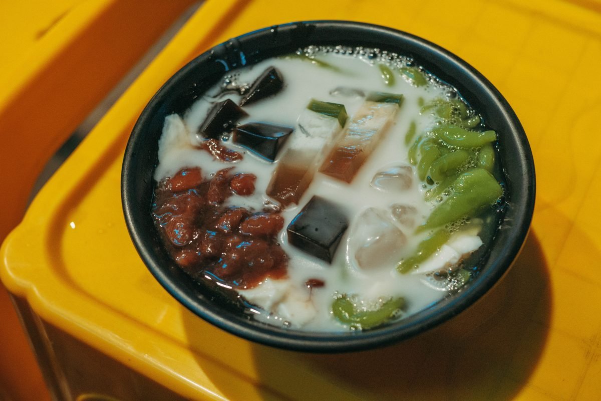 Asian dessert featuring colorful jelly cubes and red beans
