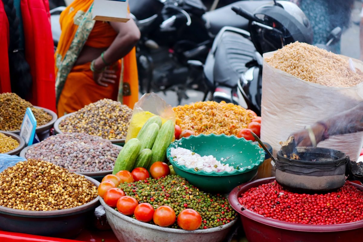 Colorful outdoor market stall featuring spices and vegetables