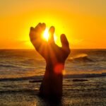 Captivating sunrise over the giant bronze hand sculpture in Pohang