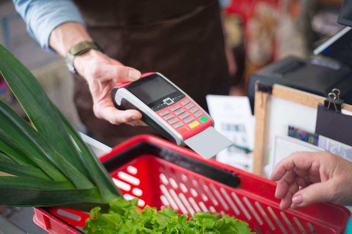 Close-up of a contactless card payment at a grocery store stall