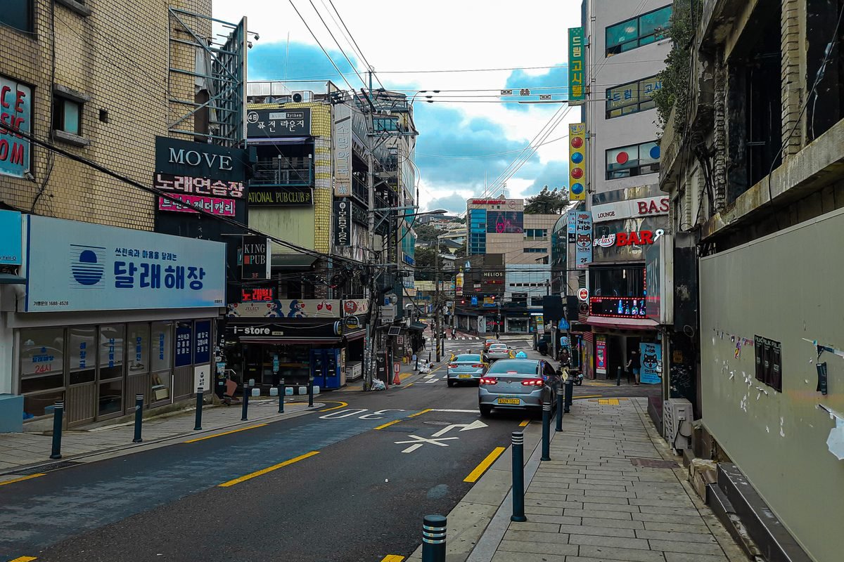 Busy street in Seoul with commercial buildings
