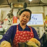 Vendor preparing food in a Seoul market