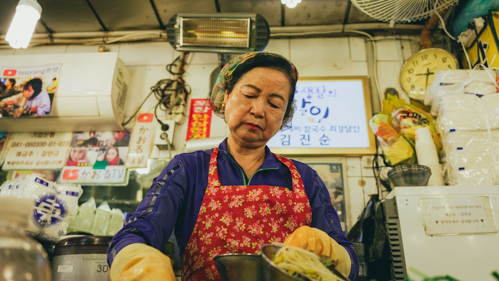 Vendor preparing food in a Seoul market