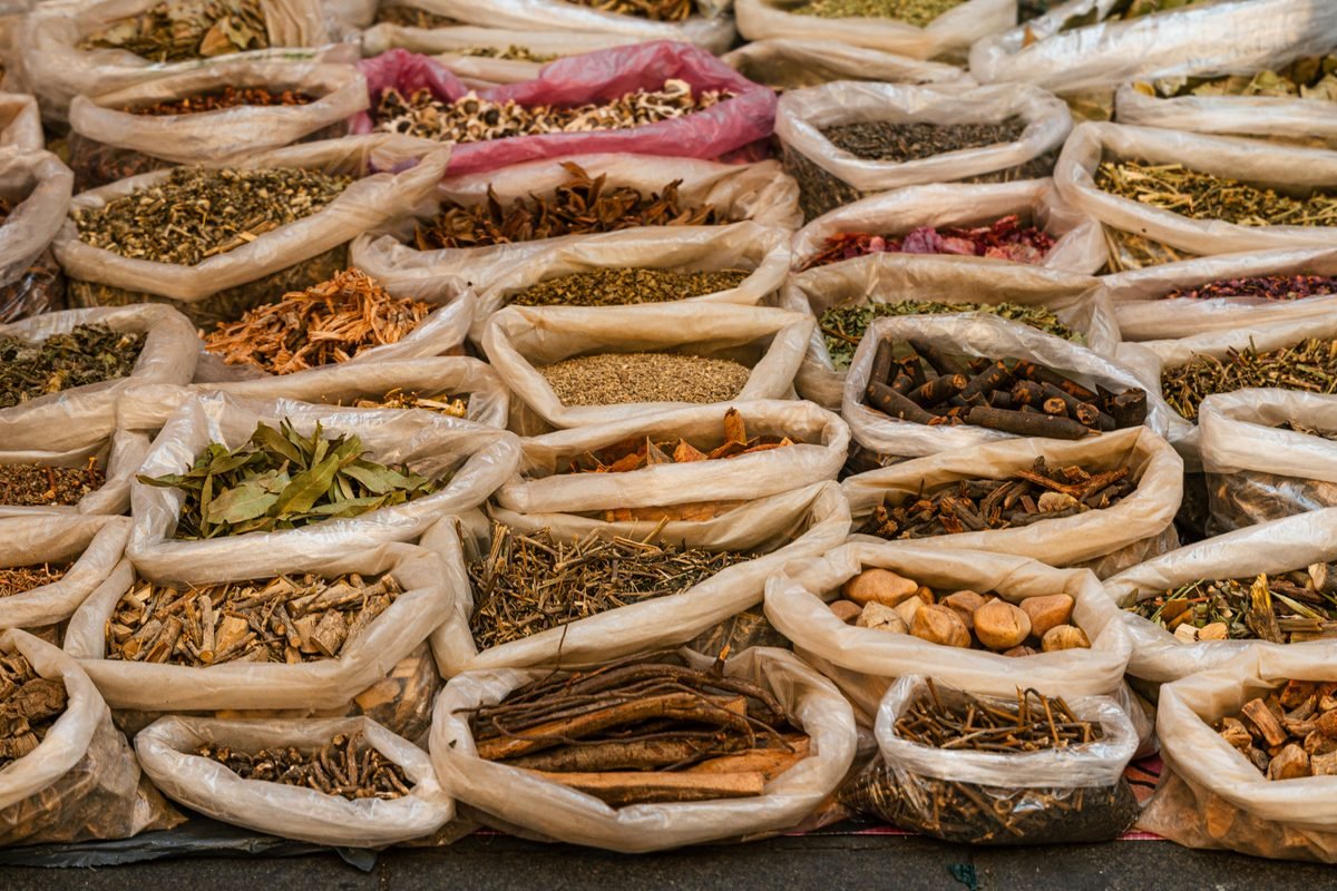 Assorted dried herbs and roots in market bags