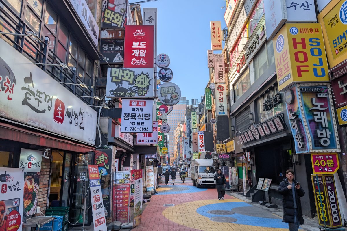 Colorful street filled with signs and people in Seoul